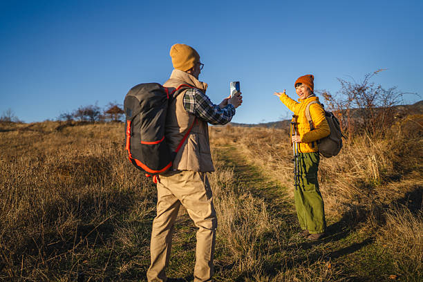 istock Couple hiking documenting journey with smart phone 2245709410