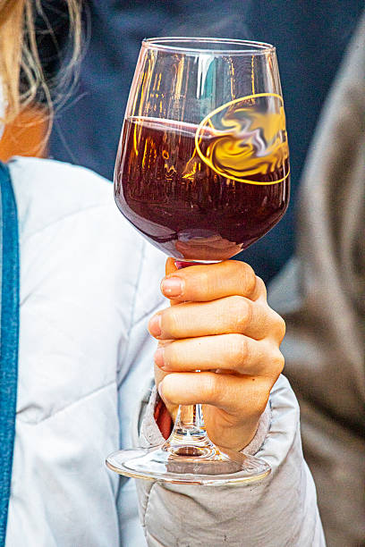 Drinking from a glass at a street holiday fair