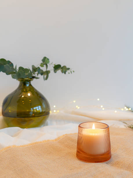 istock Cosy candle and eucalyptus in vase 2245713117