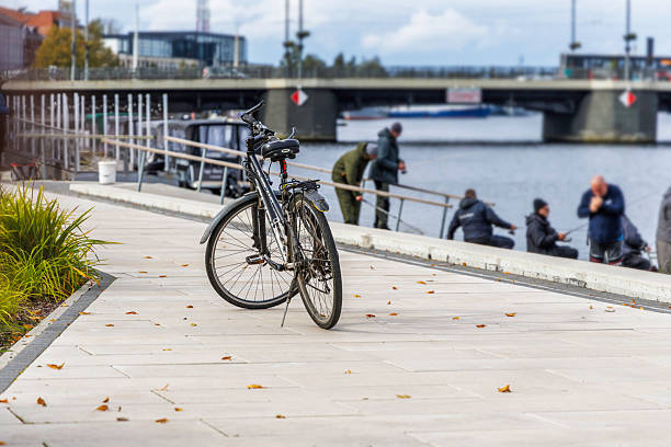 istock Bicycle on Paved Embankment with People by the Water 2245720521