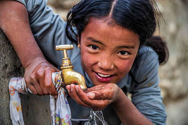 istock Nepalese girl drinking water, Upper Mustang, Nepal 2245722396