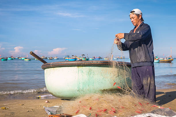 istock Vietnamese man checking fishing nets, Mui Ne 2245722502