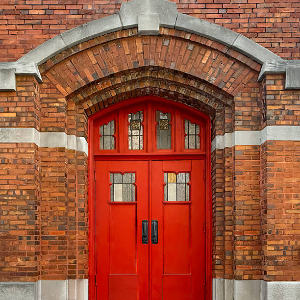 istock Red Arched Church Door with Brick Facade 2245724980