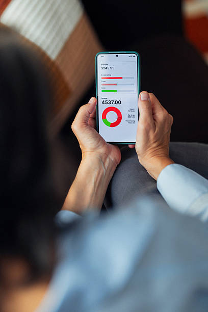 istock Person Using Smartphone With Financial Dashboard And Charts On Screen In Quiet Office 2245727889