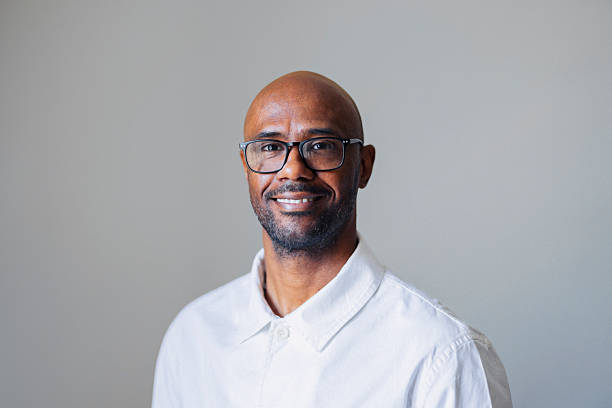 istock Smiling Bald Man With Glasses In White Button-Down Shirt Portrait For Professional Use 2245727975