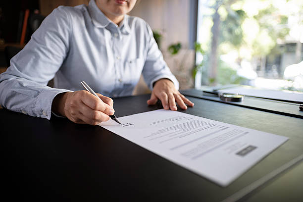 istock Lawyer signing an official document in the office 2245731401