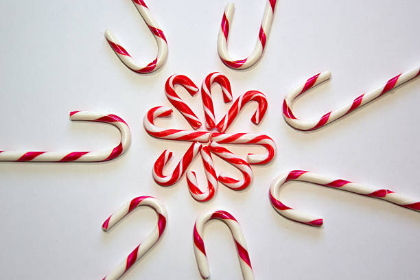 Red and white Christmas candy canes on the snow