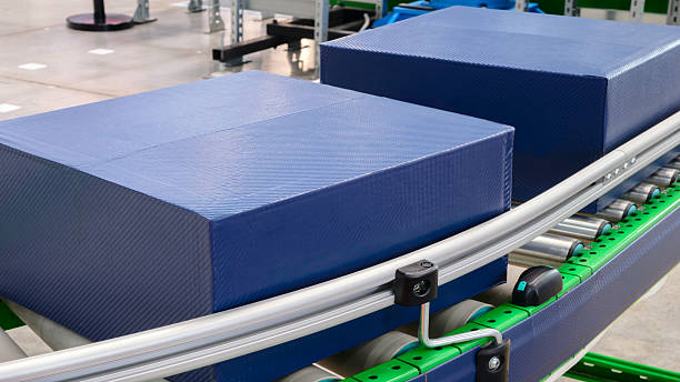 istock logistics concept background Cardboard boxes on conveyor belt of modern distribution logistics center, delivery 2245734822