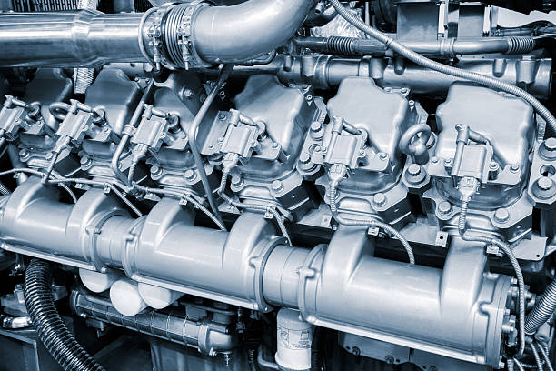 istock Large  piston gas engine electric generator with many valves and pipes. engine is orange and has many valves. 2245734902