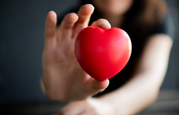 istock Woman showing red heart in her hands 2245736413