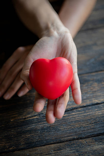 istock Woman showing red heart in her hands 2245736542