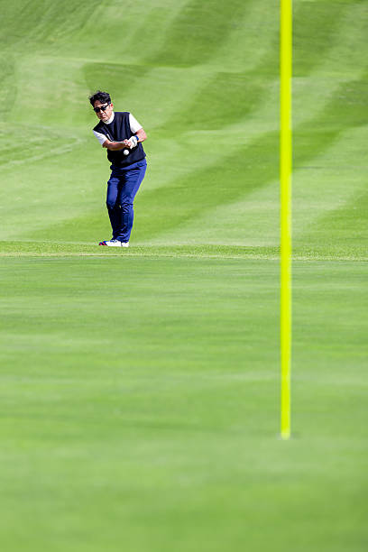 A middle-aged Japanese man enjoying golf