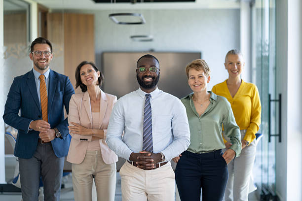 istock Smiling business team posing together in modern office 2245742392