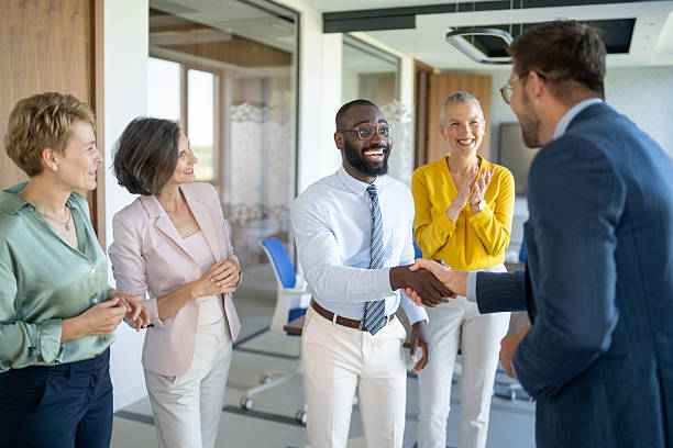 istock Business people shaking hands congratulating new partner in office 2245742396