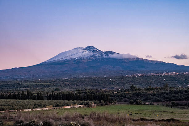 istock Snow-Dusted Mount Etna at Sunrise with Ancient Roman Aqueduct 2245745162