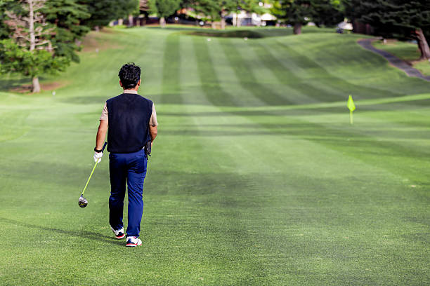 A middle-aged Japanese man enjoying golf