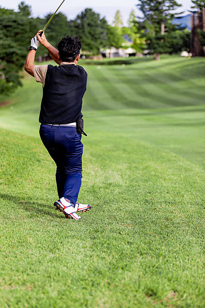 A middle-aged Japanese man enjoying golf