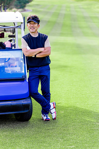A middle-aged Japanese man enjoying golf