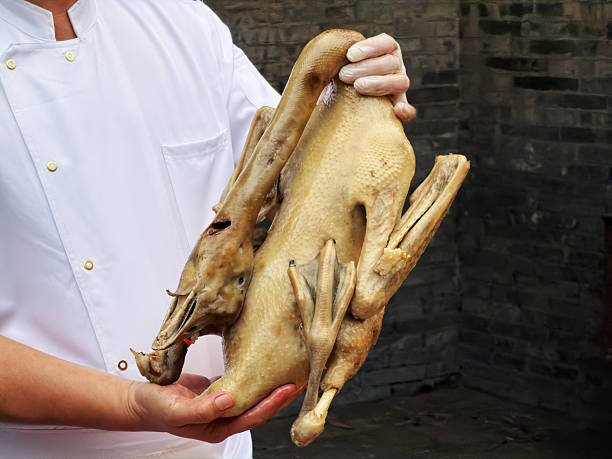istock A Cantonese chef holding a poached goose (close-up) 2245756773