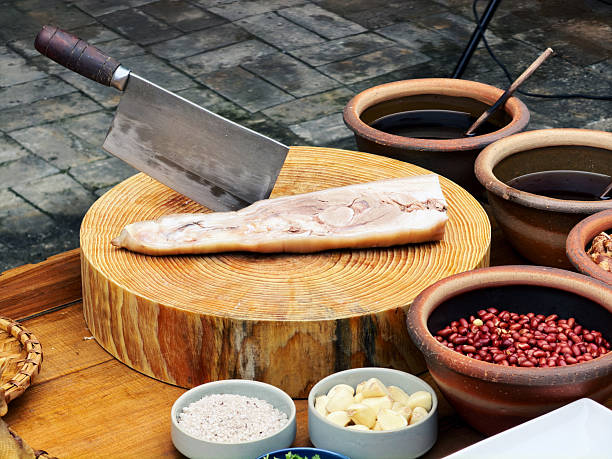 Boiled pork trotters on a cutting board in a kitchen in Bobai, Guangxi, China.