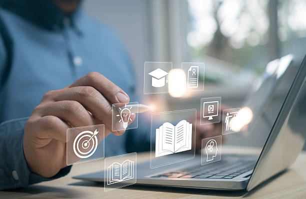 istock Businessman using laptop with digital education and e-learning icons representing online courses, knowledge management, innovation, and smart learning technology for modern education concept. 2245759627