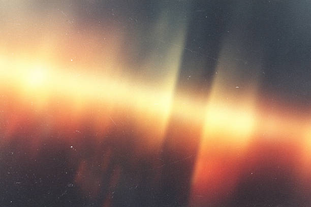 istock light leak overlay effect with dust and blur orange ray light,Abstract background with lens,retro  flim noisy grain dust texture on black background,old photo overlay texture,old film burn background 2245763184