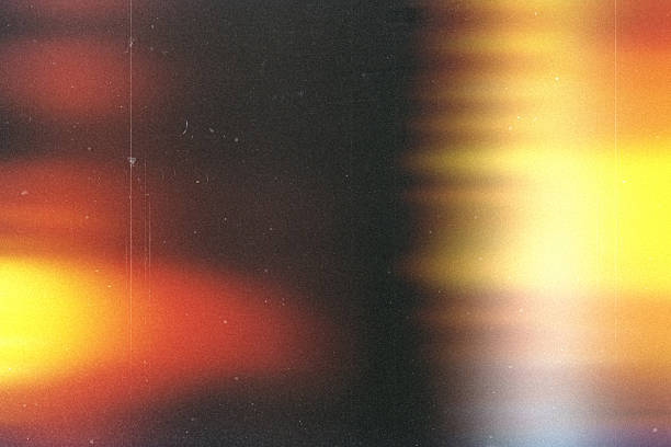 istock light leak overlay effect with dust and blur orange ray light,Abstract background with lens,retro  flim noisy grain dust texture on black background,old photo overlay texture,old film burn background 2245763188