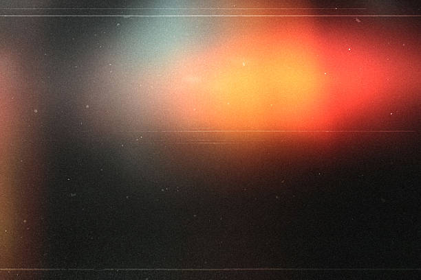 light leak overlay effect with dust and blur orange light,Abstract background with lens,retro flim noisy grain dust texture on black background,old photo overlay texture,old film burn background stock photo