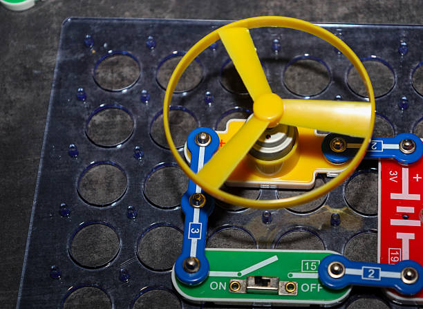 istock A fragment of an assembled electric circuit based on a construction kit, including a yellow propeller on a motor, blue connecting modules, and a green 