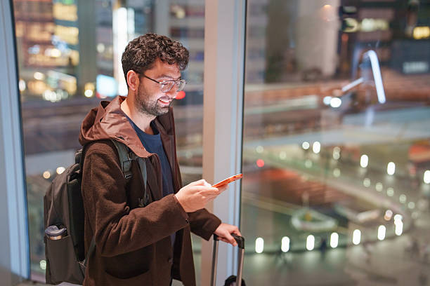 istock Urban Traveler Using Smartphone at Night in a Modern City 2245780651