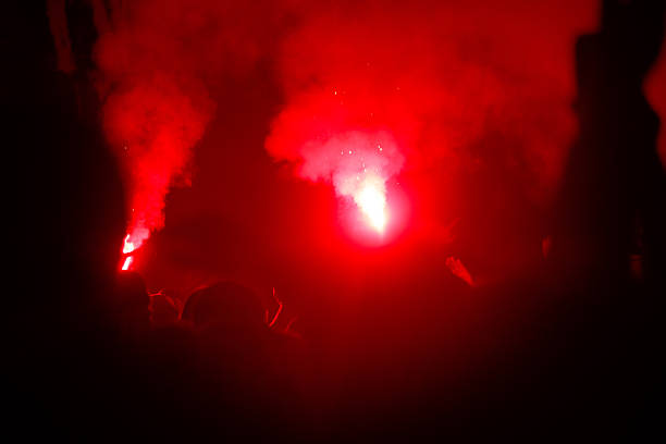 istock A red smoke filled room with people in the background 2245782374