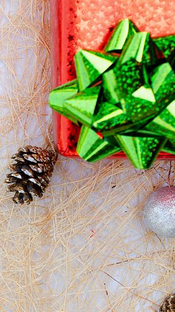 istock Festive christmas gift with pinecone and green bow 2245784320