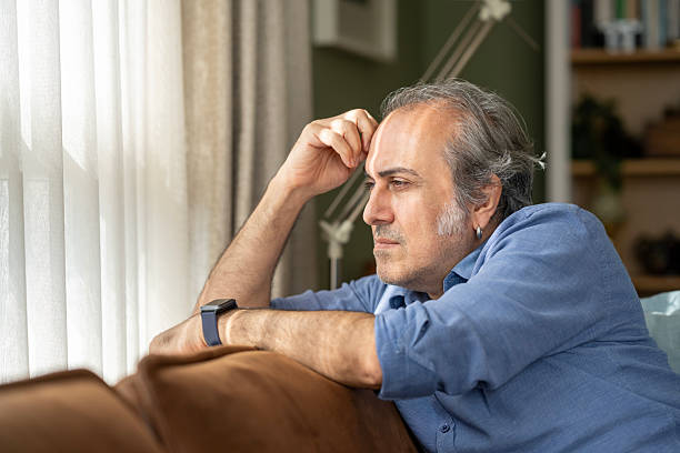 istock Man resting on a couch at home 2245786261