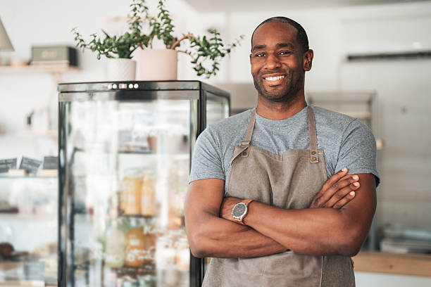 istock Cheerful young cafe owner wearing apron and smiling at camera 2245787641