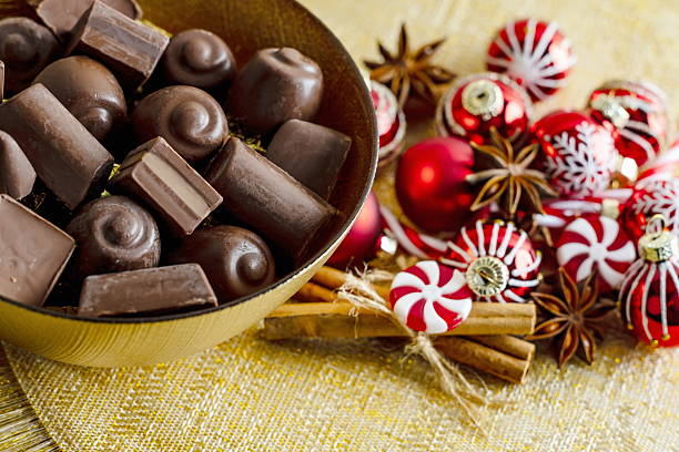 istock Chocolates with Christmas decorations on a golden background 2245791911