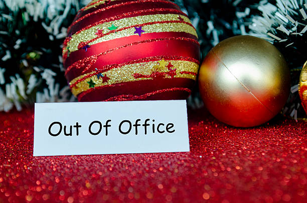 istock Out of Office text on white banner notepad with Christmas decoration background. 2245792019