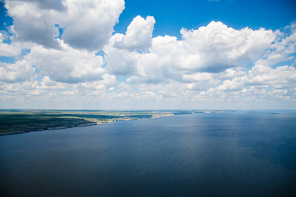 Aerial view of the river. View from the window of a helicopter flying over a beautiful landscape on a bright sunny summer day