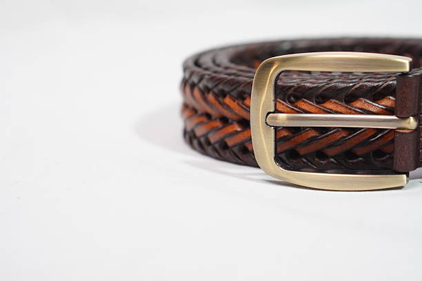 istock Intricately braided brown and tan leather belt with a rustic brass buckle, a stylish accessory 2245797732