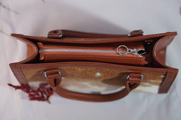 istock Spacious cowhide and leather handbag with a practical zippered interior, perfect for organization. 2245798660
