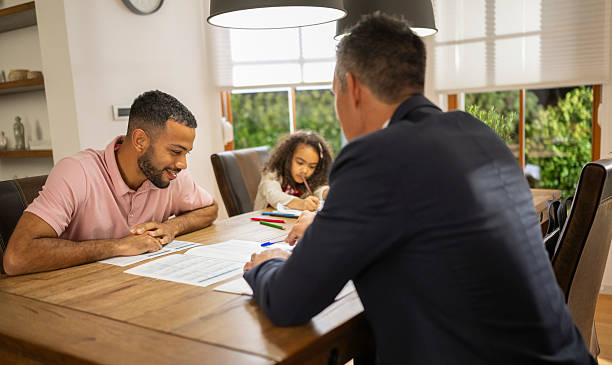 istock Male Insurance Agent Discussing Options With Single Dad 2245801224