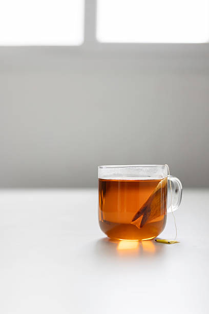 istock Clear tea cup on a white table in soft lighting 2245803212