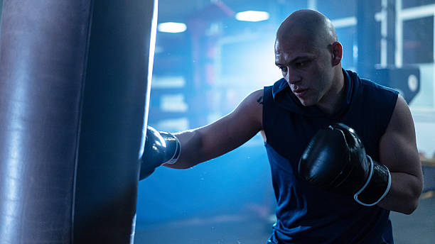 istock Focused boxer training with intensity, showcasing determination and strength in the gym environment. 2245804016