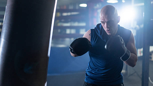 istock Focused boxer training with intensity, showcasing determination and strength in the gym environment. 2245804028