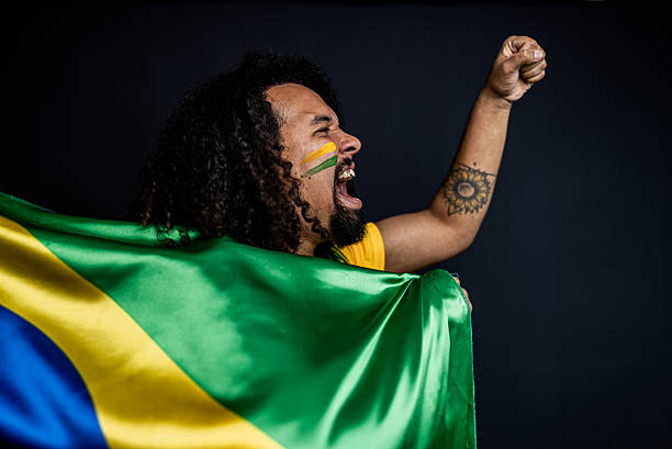 istock Young man cheering for the Brazilian team in a studio shot 2245804227