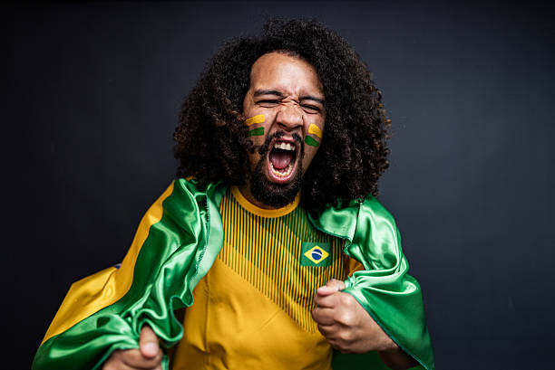istock Young man cheering for the Brazilian team in a studio shot 2245804247