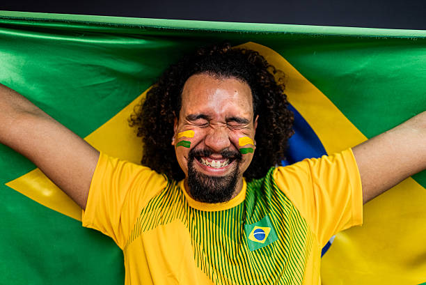 istock Young man cheering for the Brazilian team in a studio shot 2245804273