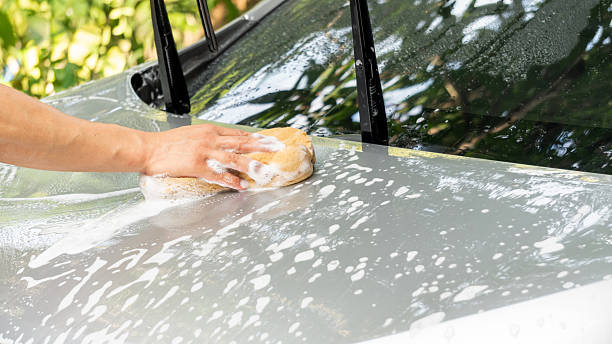 istock Man washing the silver car. 2245806795