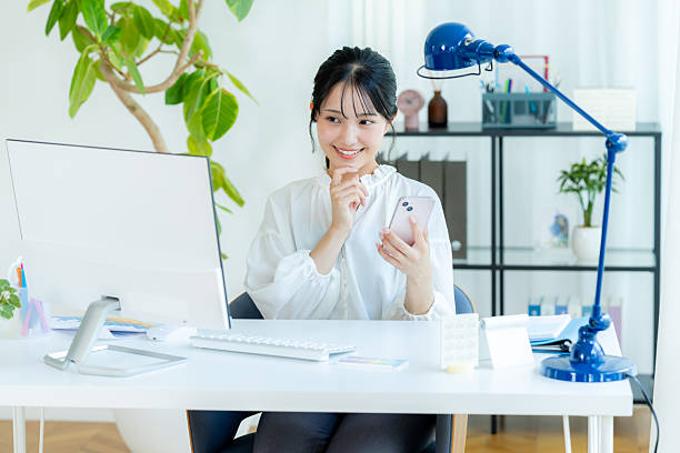 istock Business woman with smartphone in office 2245808049