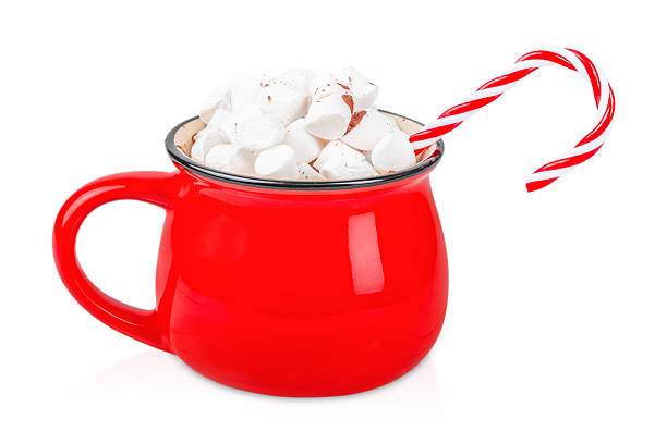 istock Red enamel mug filled with marshmallows and candy cane isolated on white background, festive winter drink concept with copy space 2245808393