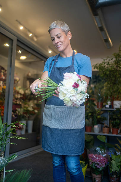 istock Woman florist arranging spring bouquet. 2245809290